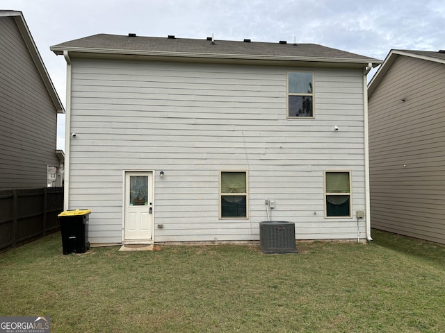 back of property with a yard and cooling unit