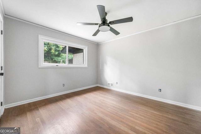 spare room with hardwood / wood-style flooring, ceiling fan, and ornamental molding