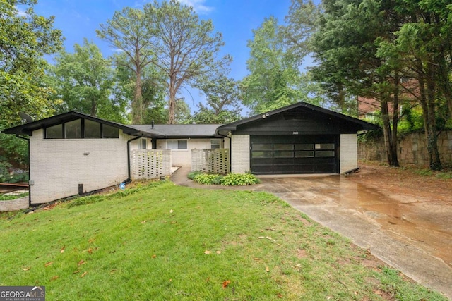 single story home with a front lawn and a garage