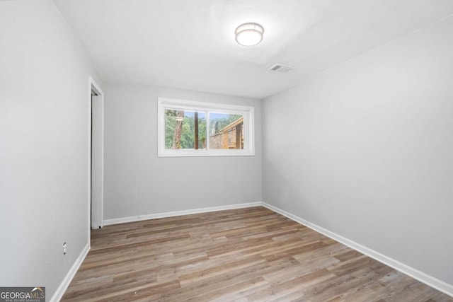 unfurnished room featuring light hardwood / wood-style floors