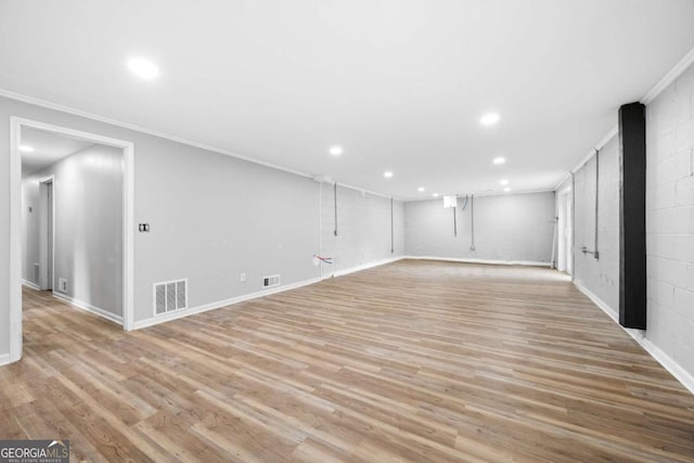 interior space featuring crown molding and light hardwood / wood-style floors