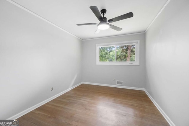 unfurnished room with hardwood / wood-style flooring, ceiling fan, and ornamental molding