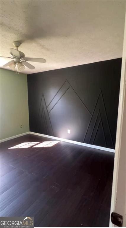 empty room with hardwood / wood-style flooring and ceiling fan