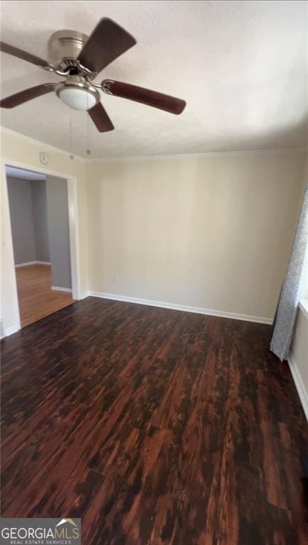 spare room featuring dark hardwood / wood-style floors and ceiling fan