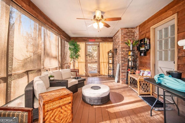 sunroom / solarium featuring ceiling fan