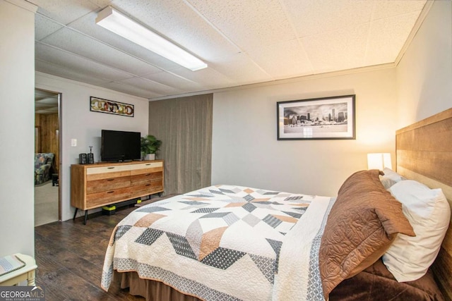 bedroom featuring dark hardwood / wood-style flooring and crown molding