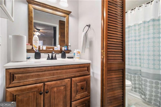 bathroom featuring ceiling fan, toilet, walk in shower, and vanity