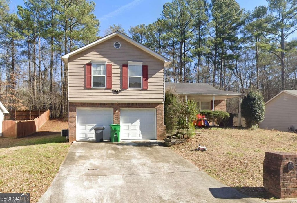 tri-level home with a garage and a front lawn