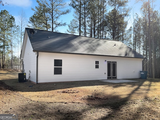 rear view of house with a patio area and central AC