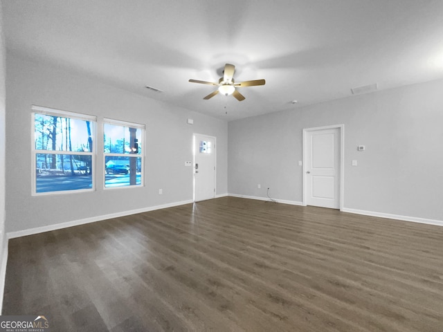 empty room featuring ceiling fan and dark wood-type flooring