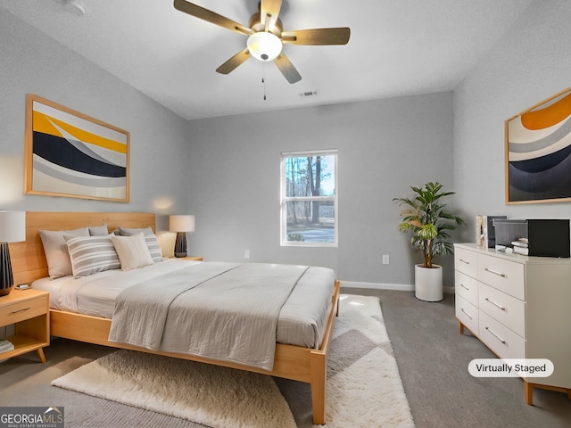 bedroom with dark colored carpet and ceiling fan