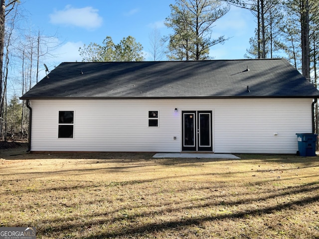 back of property featuring a yard