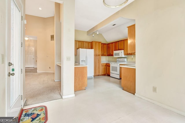 kitchen featuring lofted ceiling, light carpet, and white appliances