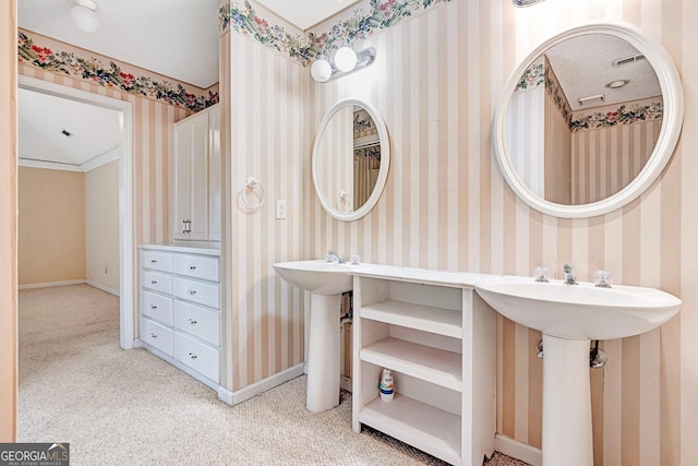 bathroom featuring ornamental molding and a textured ceiling