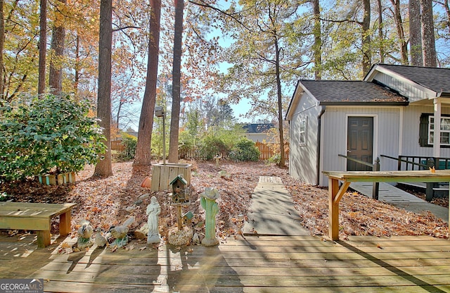 view of yard with a deck and a storage unit