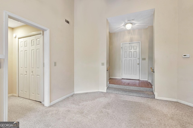 view of carpeted entrance foyer