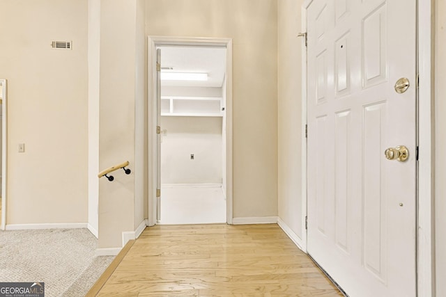 hall with light hardwood / wood-style floors