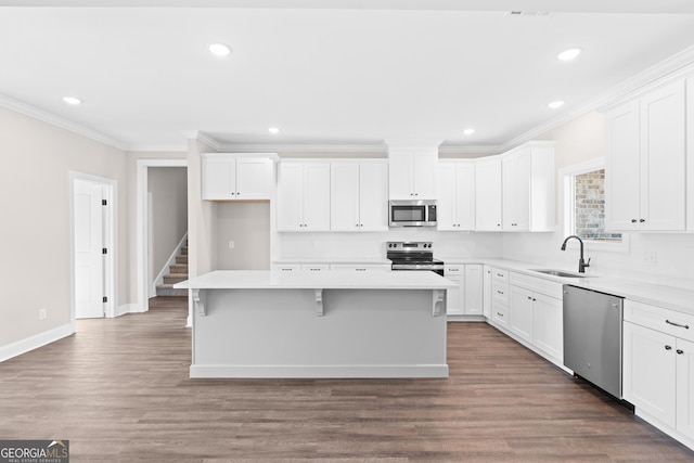 kitchen with sink, white cabinetry, a center island, and stainless steel appliances