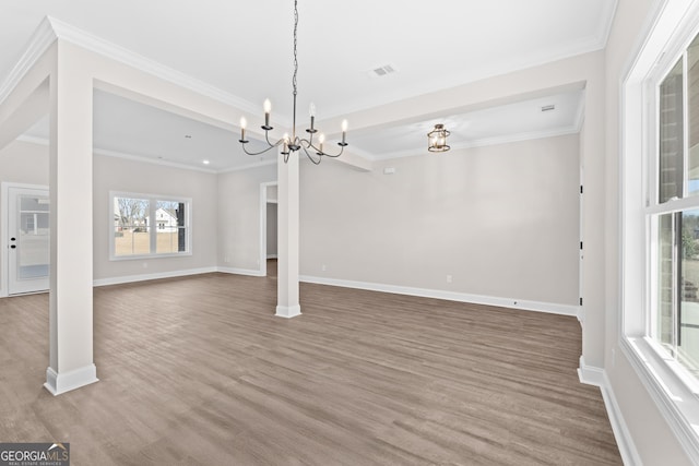 unfurnished living room featuring crown molding, wood-type flooring, and a notable chandelier