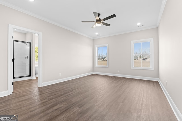 empty room with ceiling fan, dark wood-type flooring, a wealth of natural light, and ornamental molding