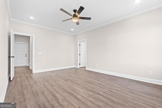 spare room with ceiling fan, hardwood / wood-style floors, and crown molding