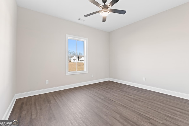 empty room with ceiling fan and dark hardwood / wood-style flooring