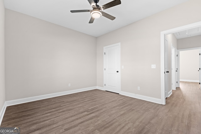 unfurnished bedroom with ceiling fan and hardwood / wood-style flooring