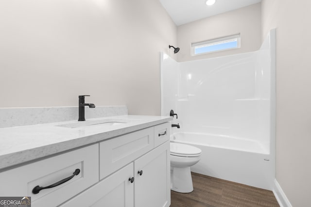 full bathroom featuring toilet, vanity, wood-type flooring, and bathtub / shower combination