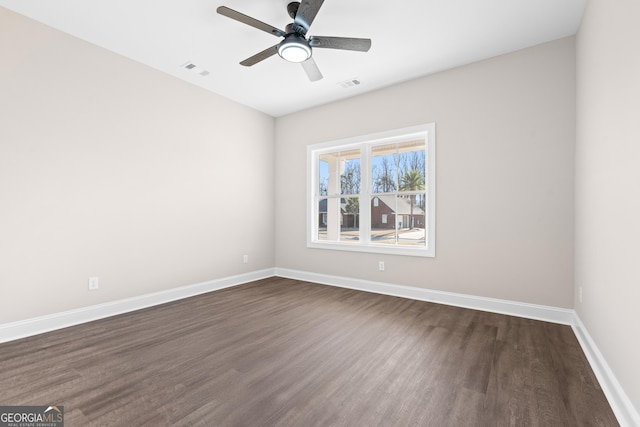 spare room with ceiling fan and dark wood-type flooring