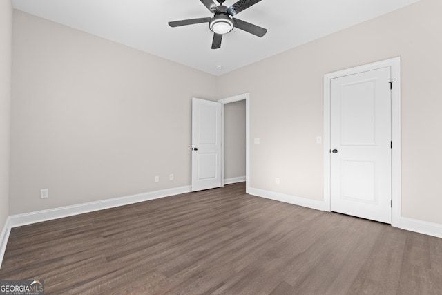 unfurnished bedroom featuring ceiling fan and dark hardwood / wood-style floors