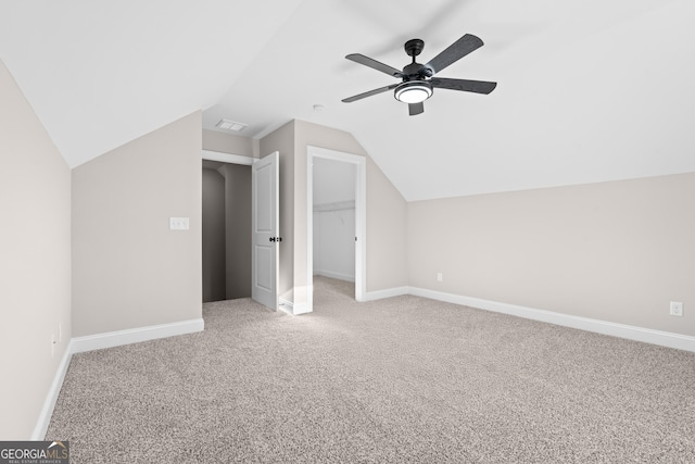 additional living space featuring vaulted ceiling, ceiling fan, and carpet floors