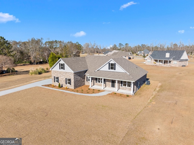 view of front of property with covered porch and a front yard