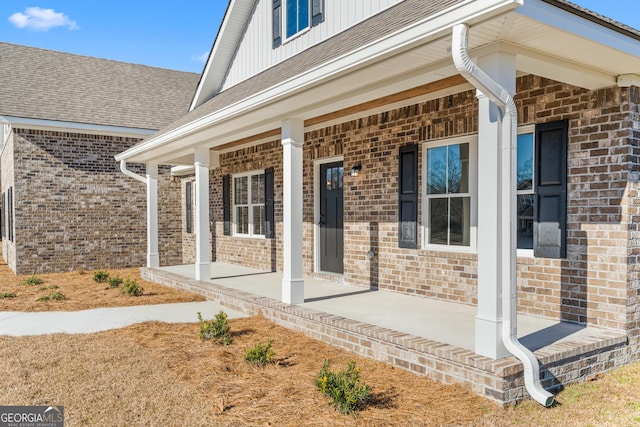 view of exterior entry with covered porch