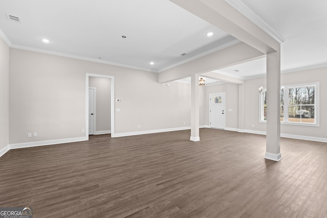 unfurnished living room with an inviting chandelier, dark wood-type flooring, and crown molding