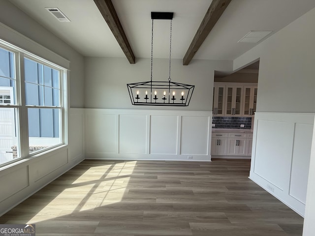 5613 Meadow View Dr, Jefferson, GA 30549 - unfurnished dining area featuring an inviting chandelier, beam ceiling, a decorative wall, a wainscoted wall, and visible vents