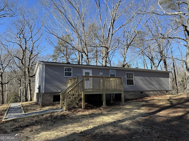 rear view of house with a wooden deck