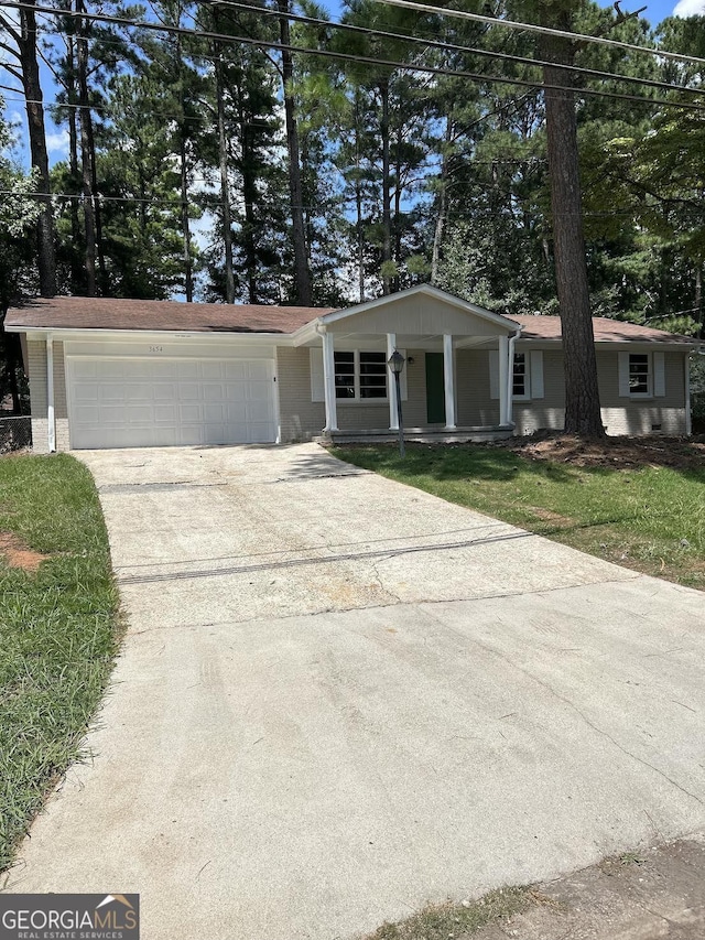 ranch-style house with a garage and a front yard