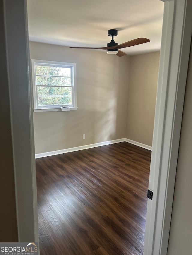 unfurnished room featuring dark hardwood / wood-style floors and ceiling fan