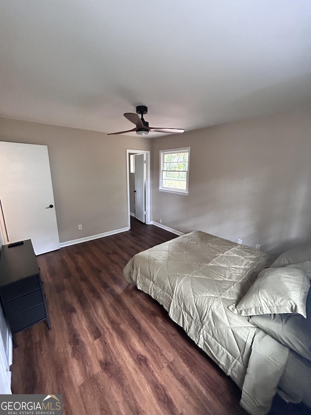 bedroom with ceiling fan and dark wood-type flooring