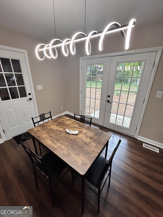 dining area with dark hardwood / wood-style flooring and french doors