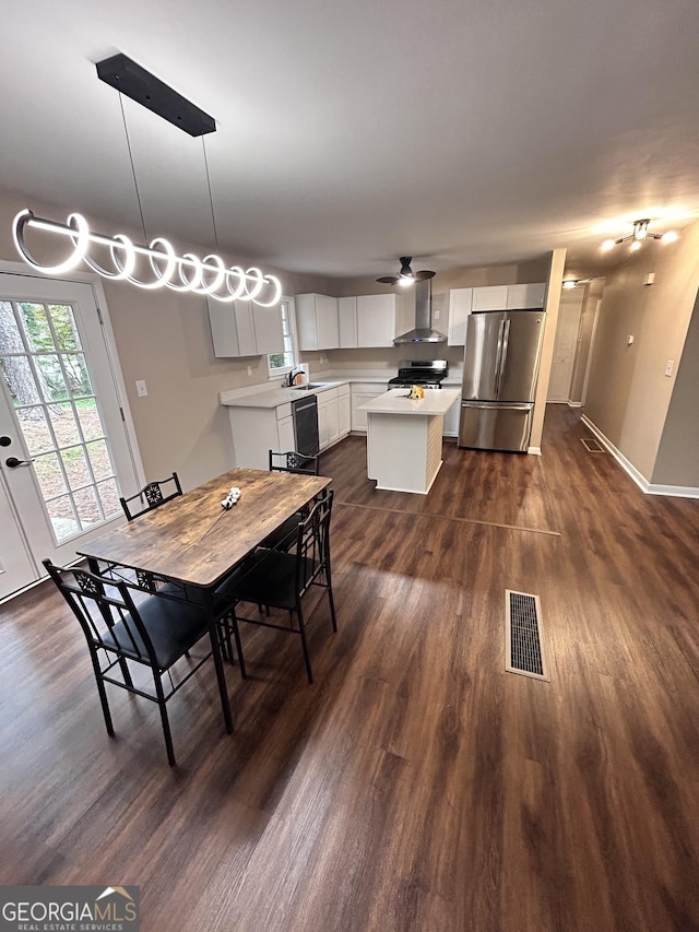 dining room with dark hardwood / wood-style flooring, ceiling fan, and sink