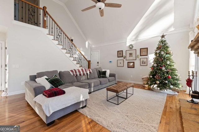 living room with hardwood / wood-style floors, ceiling fan, and crown molding