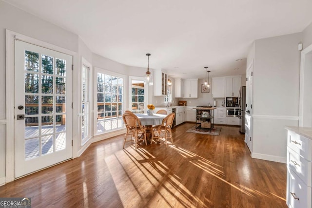 dining space featuring dark wood-type flooring