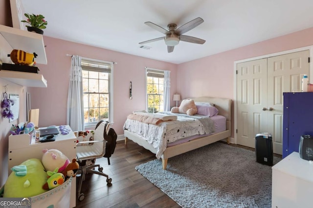 bedroom with ceiling fan, dark hardwood / wood-style flooring, and a closet