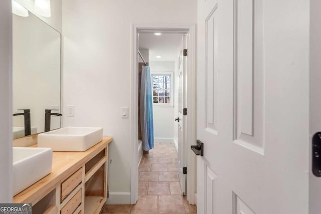 bathroom with tile patterned flooring and vanity