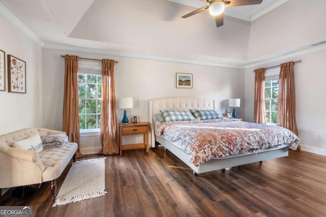 bedroom featuring a tray ceiling, ceiling fan, ornamental molding, and dark hardwood / wood-style floors