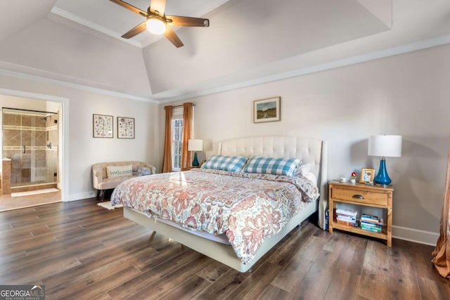 bedroom with ensuite bathroom, ornamental molding, a raised ceiling, ceiling fan, and dark wood-type flooring