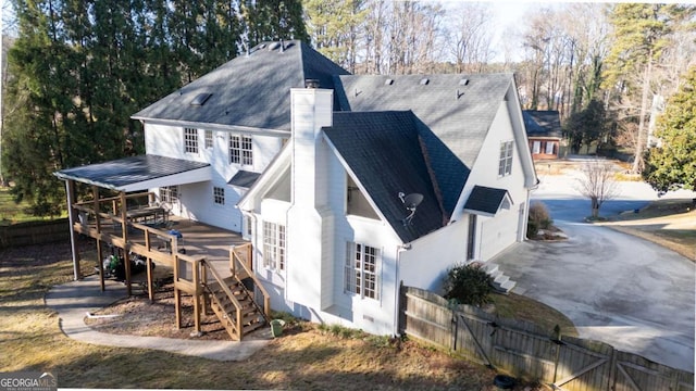 rear view of property featuring a deck