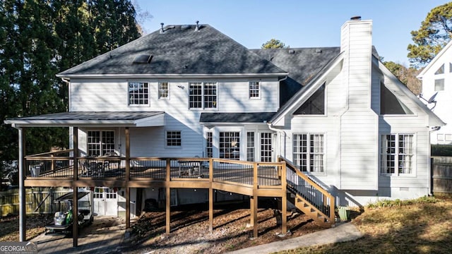 rear view of property featuring a wooden deck