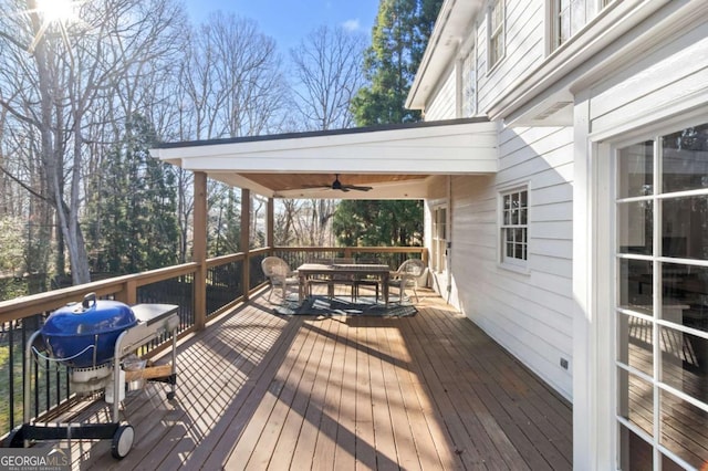 deck featuring ceiling fan and a grill